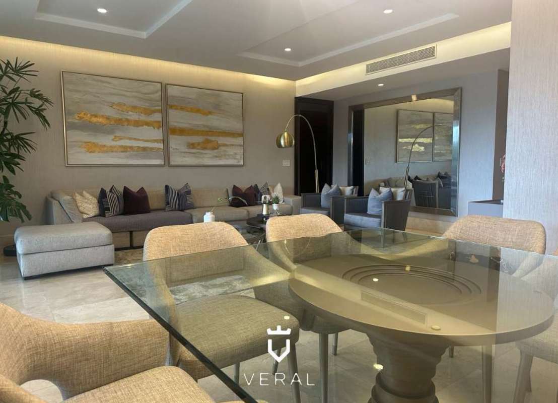 Spacious modern living room with marble floor, large glass doors opening to terrace in PH The Reserve Santa Maria Panama