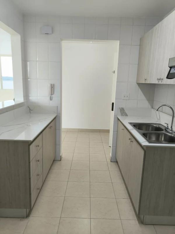 Modern kitchen with cabinetry, utility sink and window PH Majestic Gardens