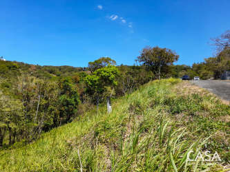 Grassy slope with paved road adjacent at Montana Verde gated community Boquete Panama