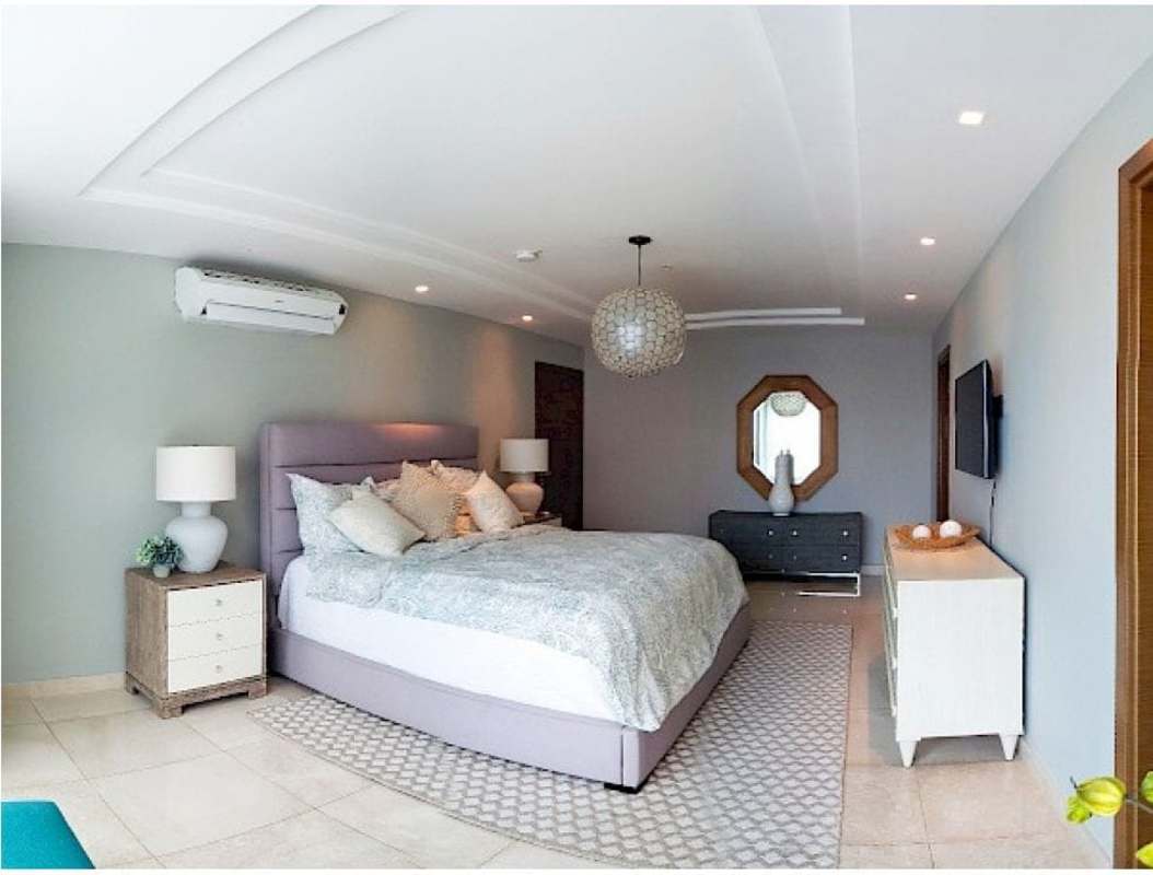 Double height luxury lobby with mirror panels and elegant lighting in PH Parklane Costa del Este Panama