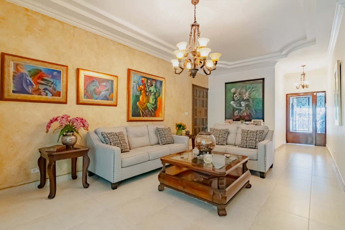 Entryway with art, lighting fixture, porcelain floor at remodeled La Loma residence Panama
