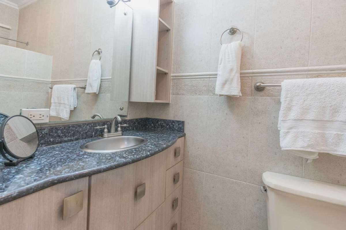 Contemporary bathroom with beige tiling and granite vanity La Loma Panama