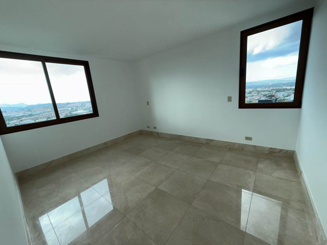 Large living room with panoramic windows and city views in Santa María luxury apartment