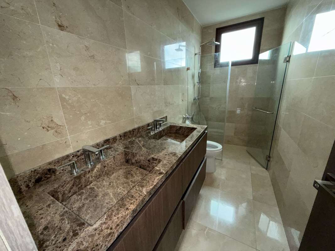 Modern bathroom marble countertop double sink glass-enclosed shower Santa María Panama