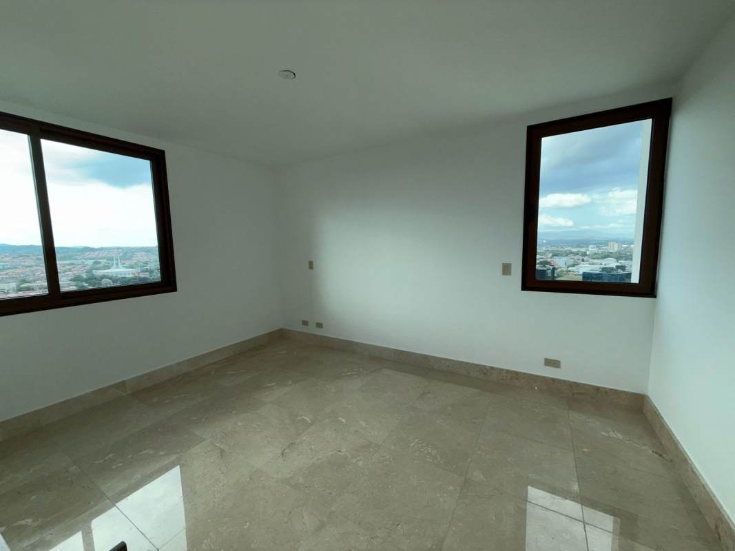 Spacious modern walk-in closet with wood built-ins in Santa María apartment