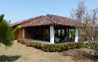 Rustic kitchen with stove, fridge, tiled backsplash in Pedasí Panama