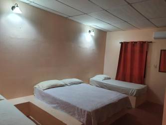 Bedroom with multiple beds AC closet curtain Equus Village Pedasí Panama