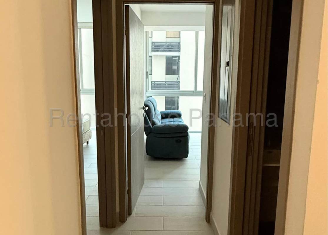 View from hallway into bright living room with large windows PH Urbana Obarrio Panama