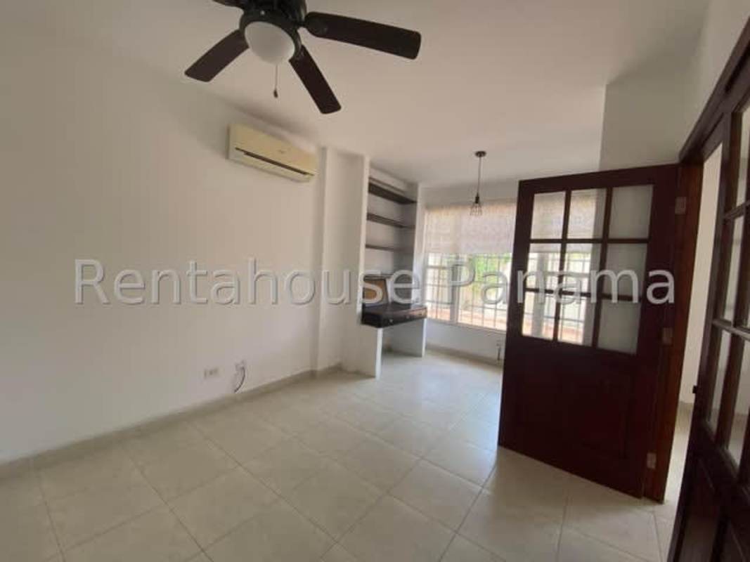 Bright open living room with tiled floors ceiling fan and terrace access Villa Valencia Costa Sur Panama