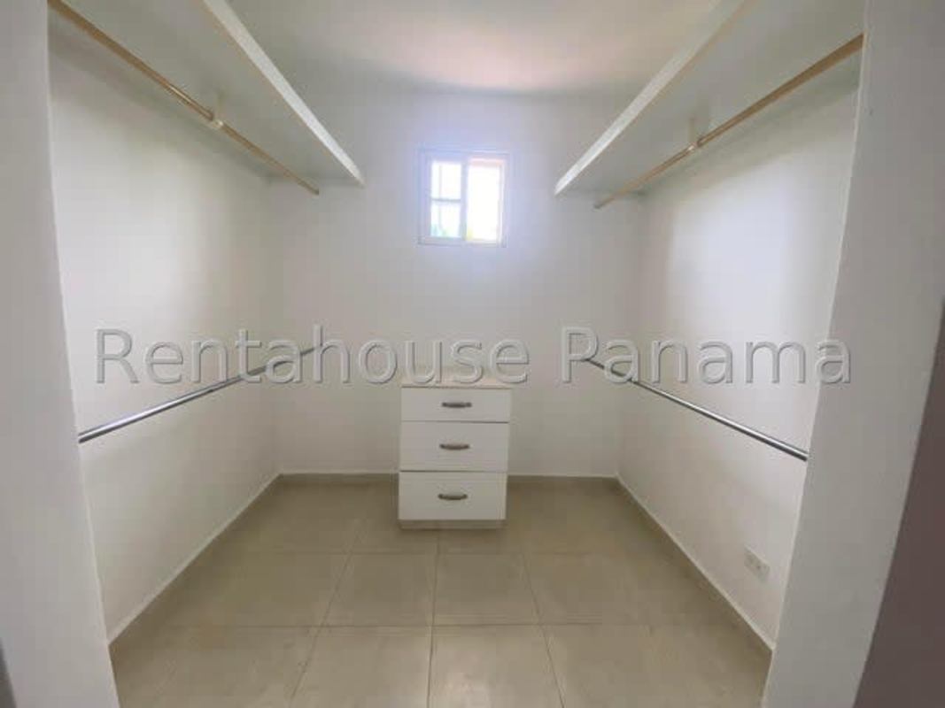 Walk-in closet with natural light and shelving Villa Valencia Costa Sur Panama