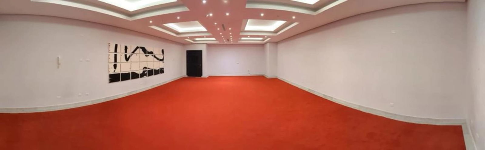 Contemporary living room with recessed lighting and red carpet in PH Park City apartment rental Panama