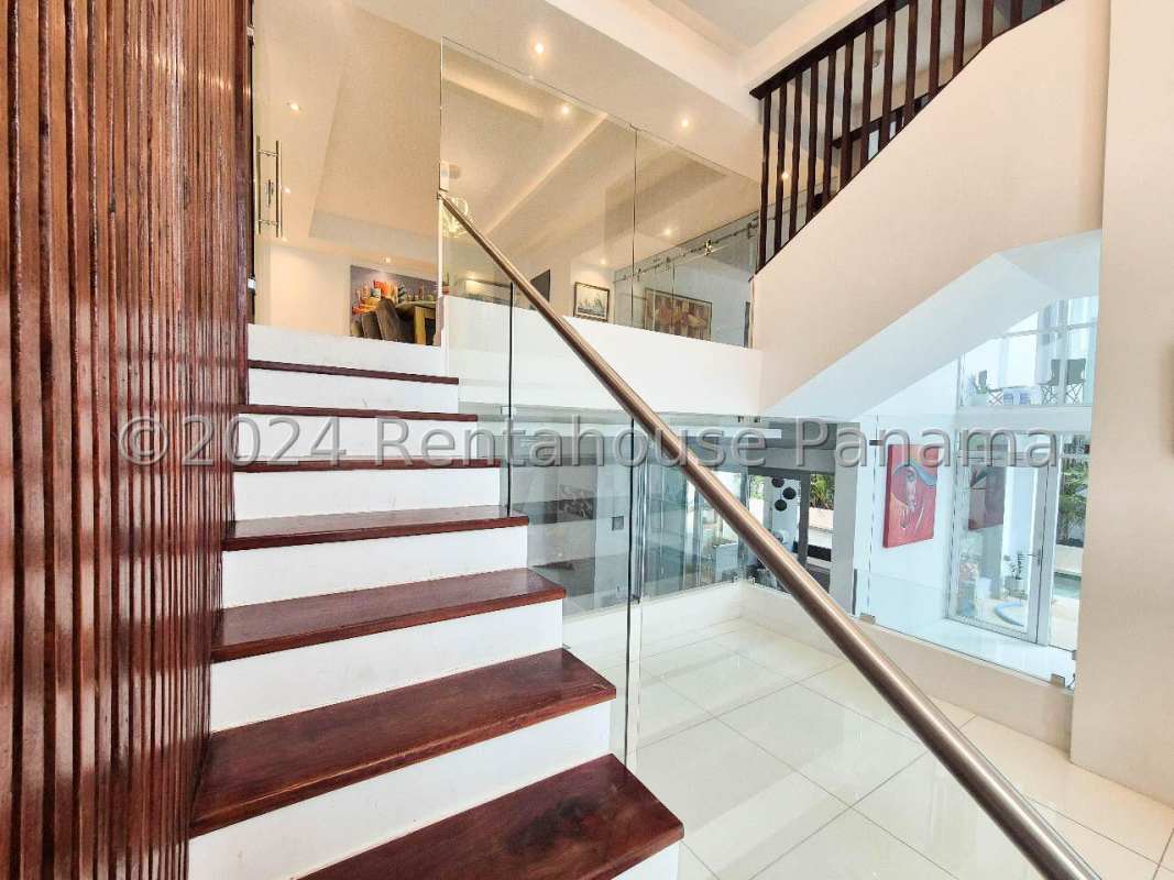 Bright entry hall with glass doors, decorative elements, minimalist art in Altos del Golf Panama