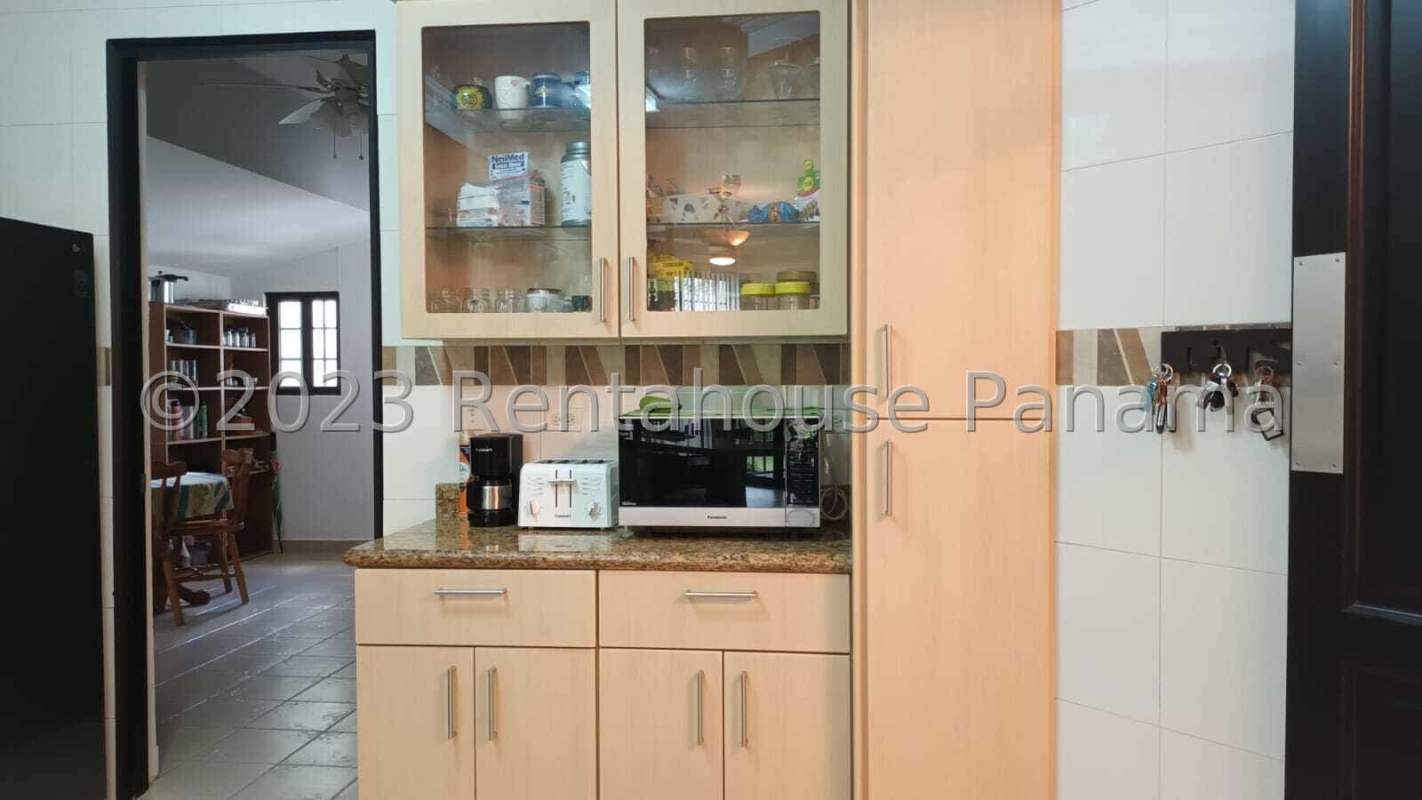 Spacious kitchen with granite counters and wood cabinets in luxury home Altos de Panamá Panama