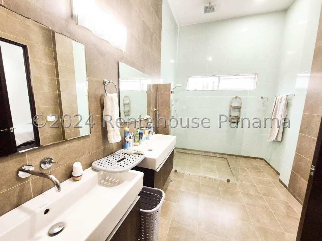 Master bedroom with large windows and cozy minimalist design in luxury home Altos del Golf Panama