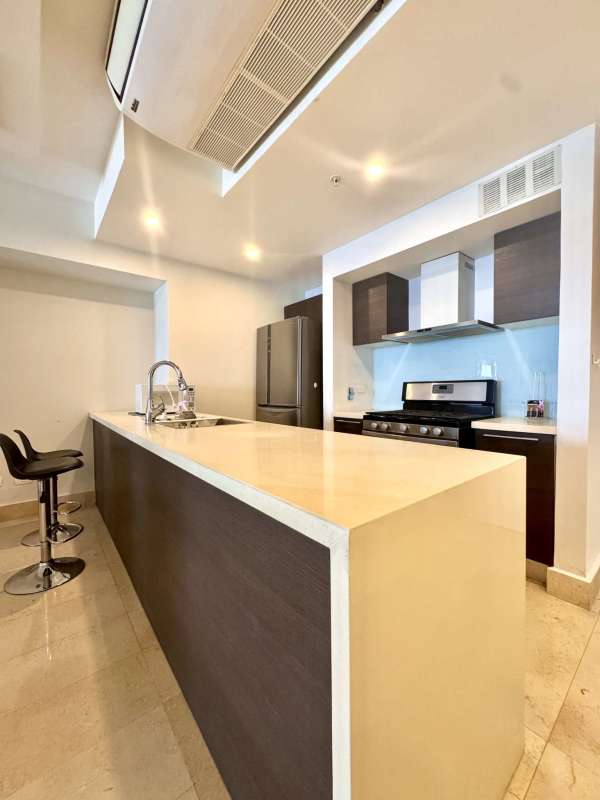 Fully equipped contemporary kitchen with island and stainless steel appliances at Yoo Panama