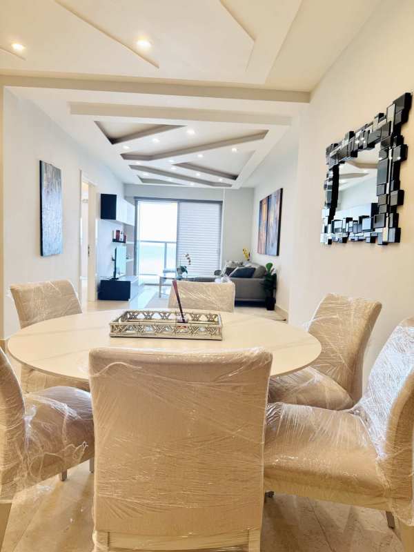 Contemporary dining and living space with oceanfront windows in Yoo Panama