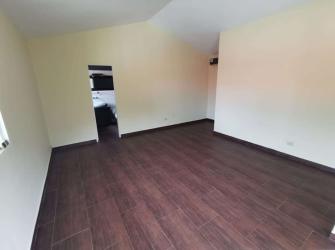 Bright bedroom with bay window, ceiling fan, tile flooring in Villas de Howard house Panama Pacifico