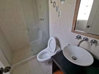 Interior staircase with wooden railing, tile floor connecting levels in Howard Panama