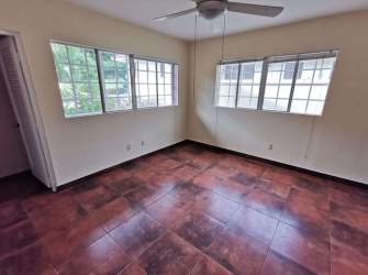 Empty bright bedroom with ceiling fan ceramic tile in Villas de Howard house Panama Pacifico