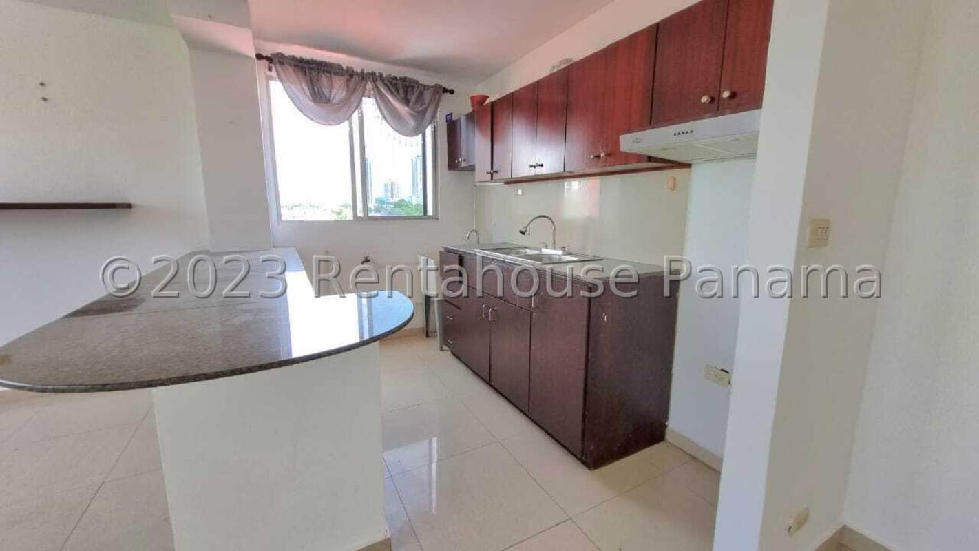 Kitchen with granite counters, large window, and wood cabinets PH Altos del Golf Panama