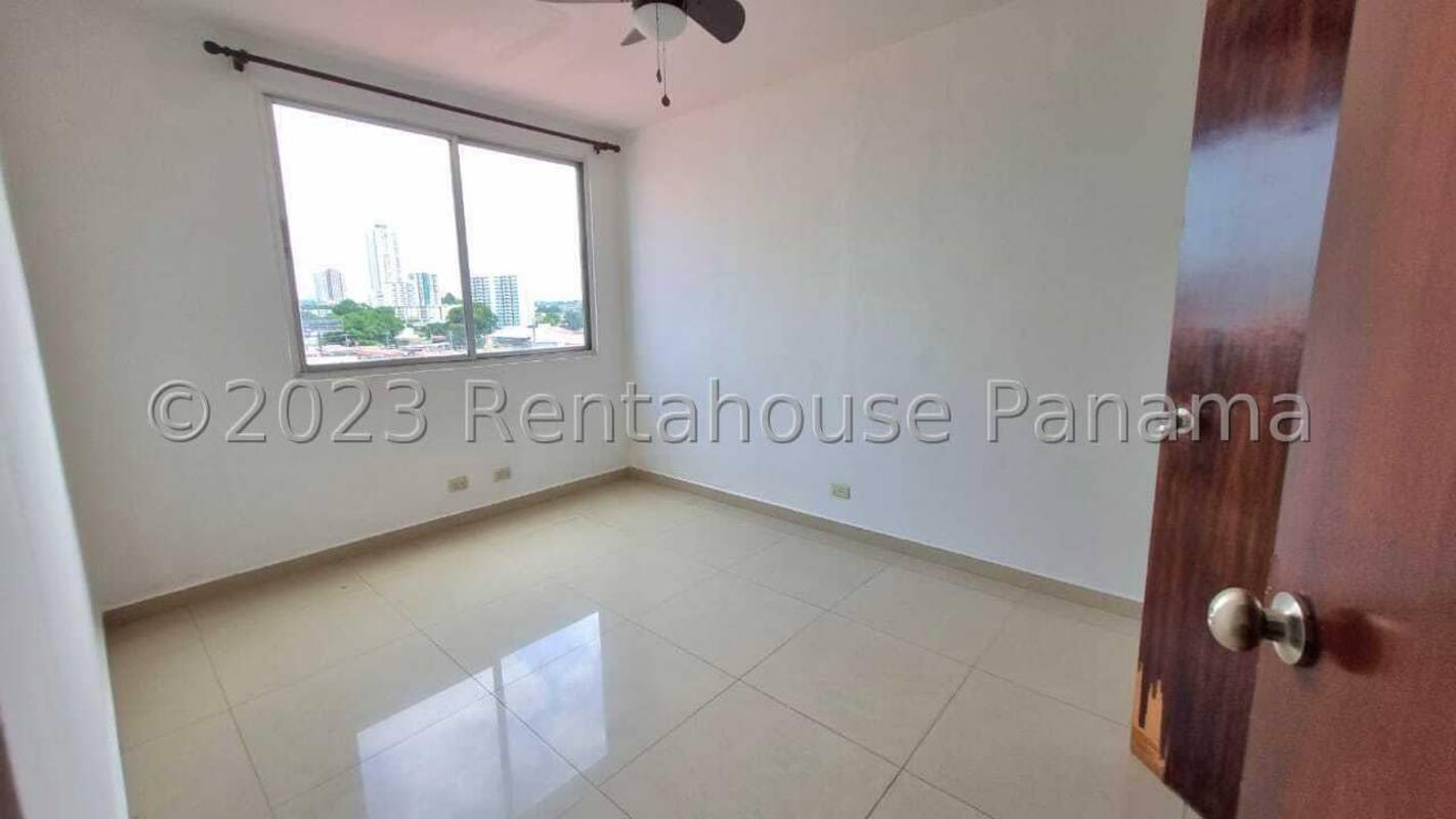 Second bedroom with built-in closet and window overlooking neighborhood Panama City