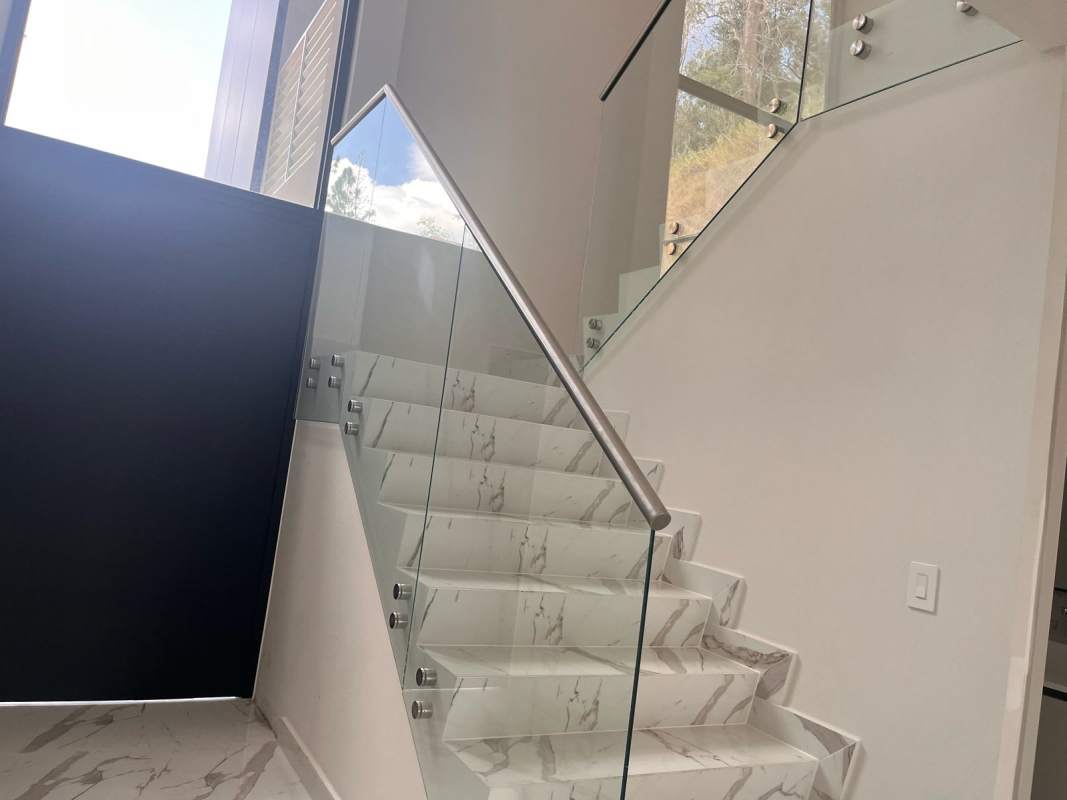 Elegant staircase with glass railing and marble flooring in Albrook 9 luxury house Panama