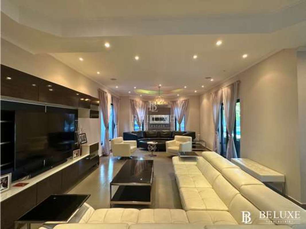 Modern living room with large windows, neutral decor and ample space in Costa del Este Panama