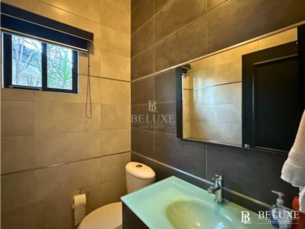 Contemporary kitchen with island stainless appliances and cabinetry in Costa del Este Panama house