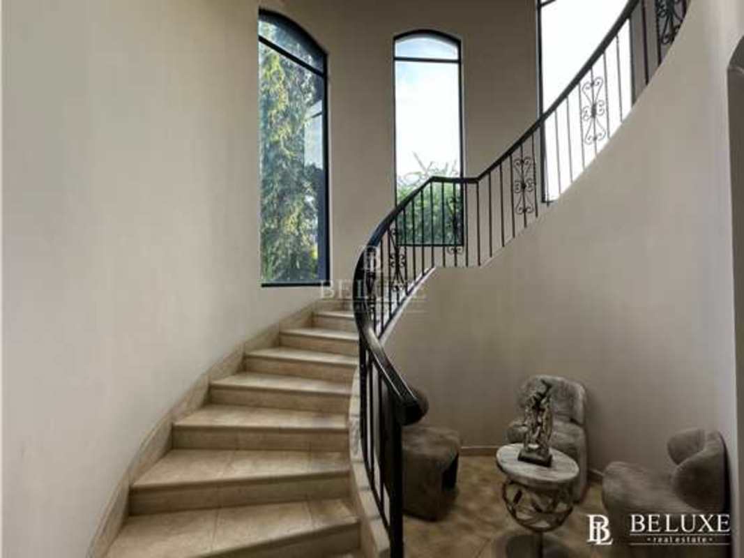 Master bedroom with large windows and neutral colors in Costa del Este Panama