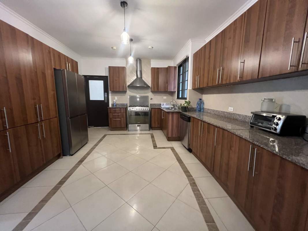 Spacious covered patio with fans, tiled floor and garden views in Clayton Panama rental home