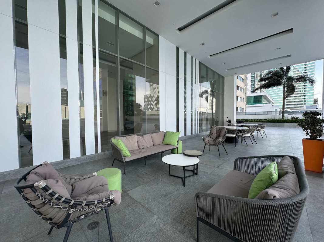 Modern outdoor covered terrace lounge with furniture and city views Costa del Este