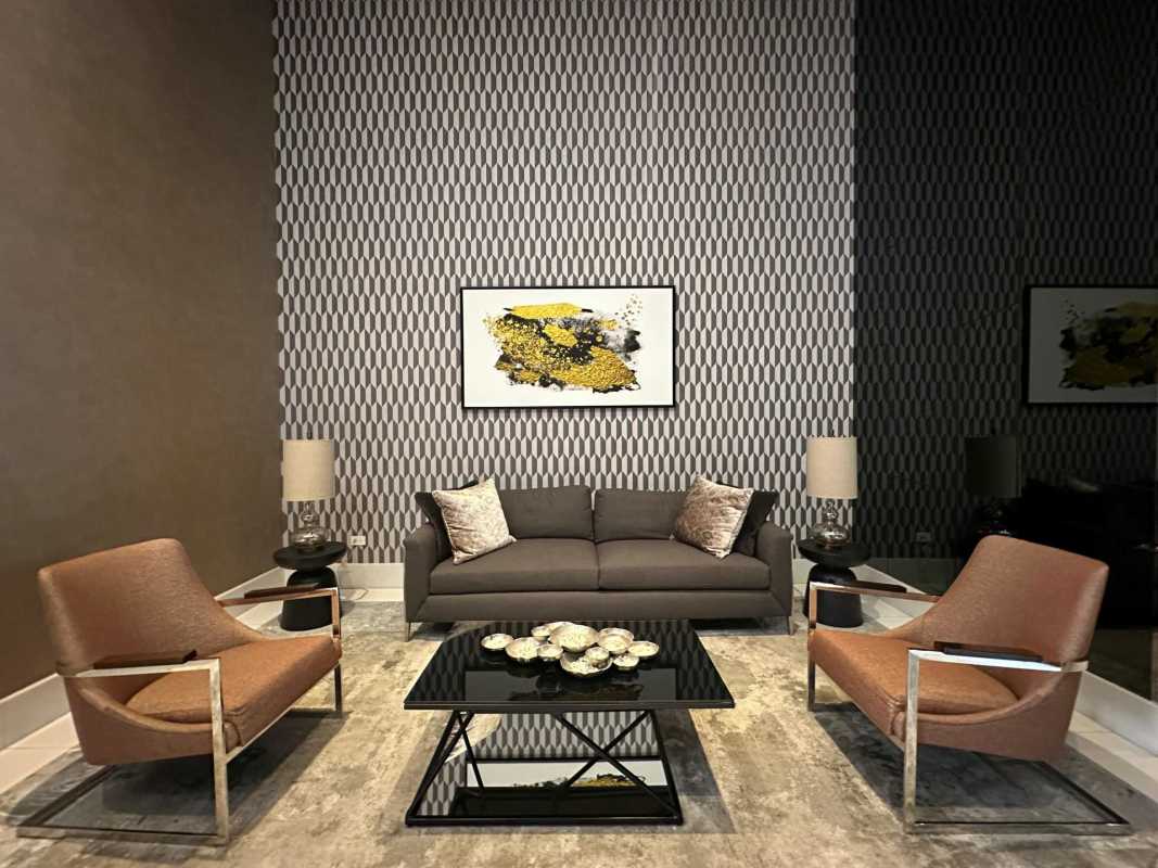 Spacious living room featuring geometric wallpaper modern furniture Costa del Este condo