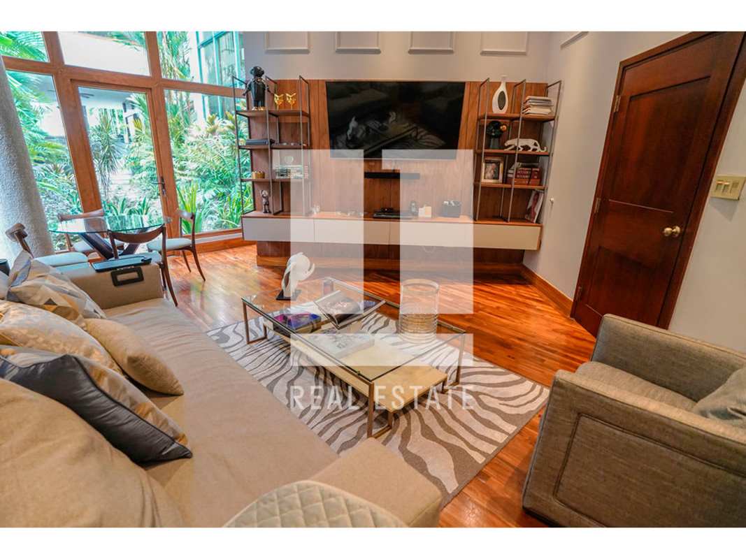 Open concept living dining area with hardwood floors garden view luxury home Altos del Golf Panama City