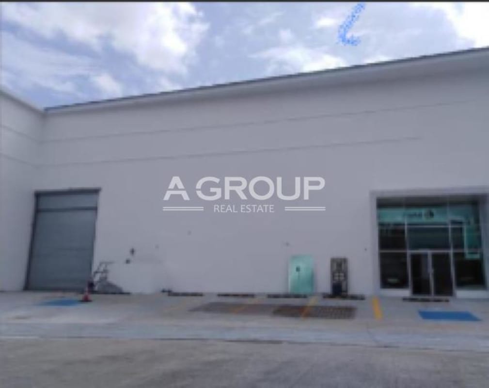 Contemporary business complex with glass offices, parking area, landscaped surroundings at Panamá Viejo, Panama