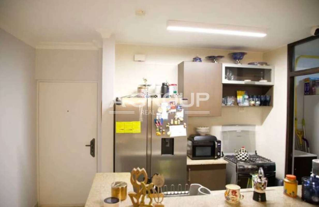 Kitchen with granite countertops, dark cabinetry, stainless appliances PH Pacific Sun Panama City