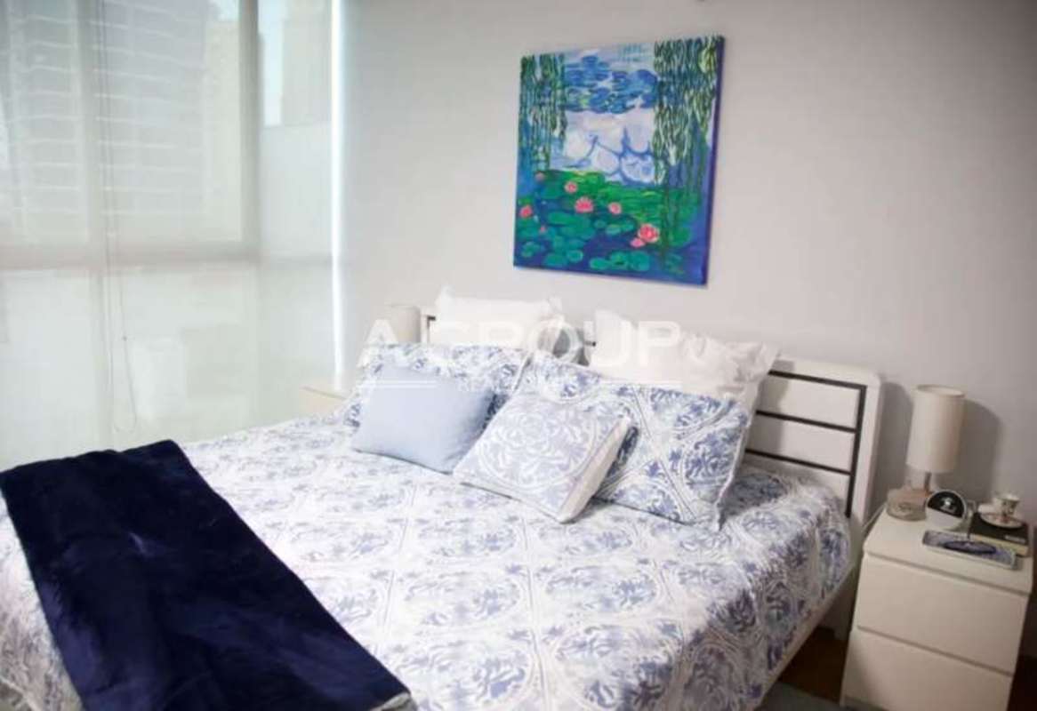 Bedroom featuring king bed, decor accents, large window PH Pacific Sun Punta Pacifica Panama City