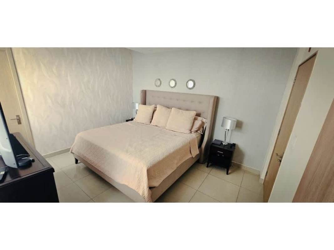 Neutral master bedroom with upholstered bed, elegant decor in PH South Coast Panama