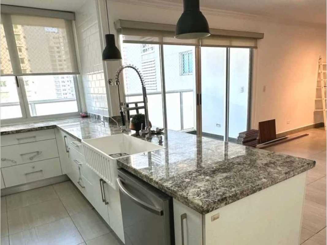 Modern living room with wood accent wall, tile flooring, ceiling fan, PH Moon Tower