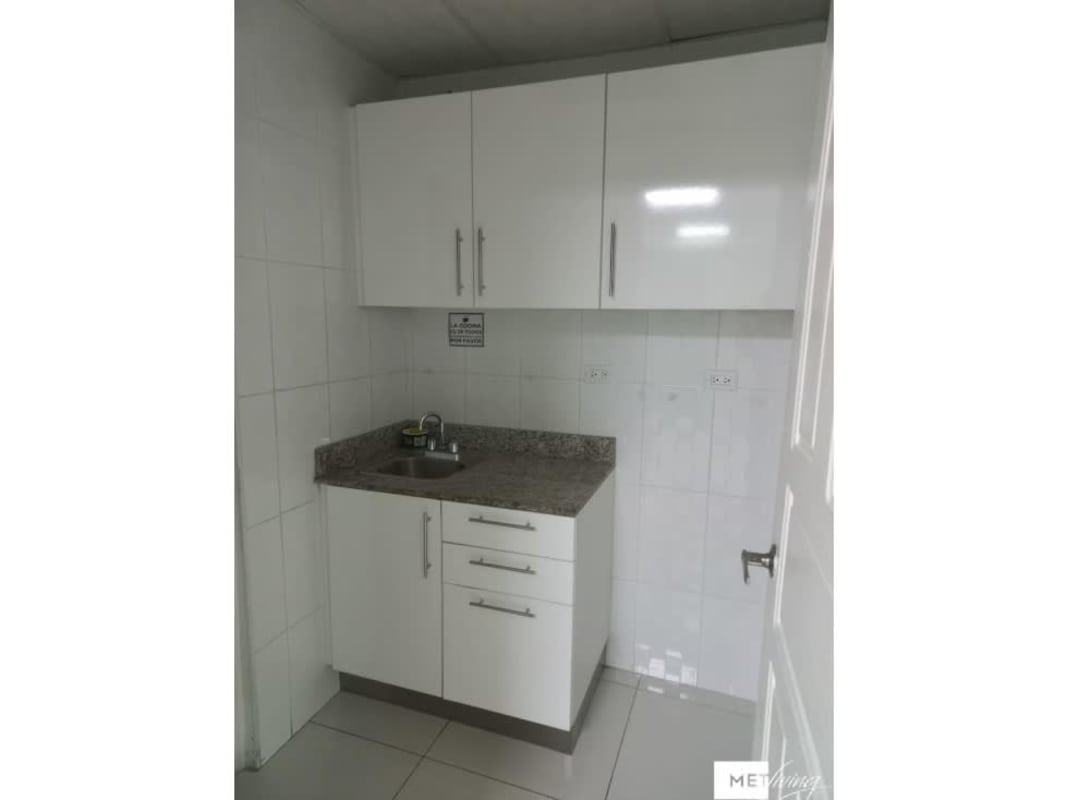 Compact kitchen with granite countertop and cabinets in office El Cangrejo Plaza Panama