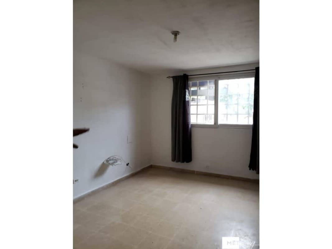Empty room or bedroom with tiled floor, white walls, windows with security bars Villa Lucre Panama