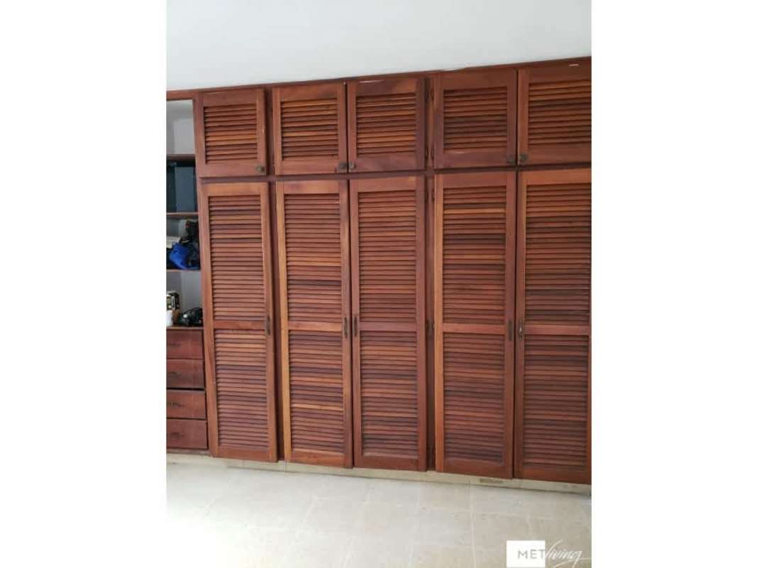 Bedroom with tile floors, white walls, window security bars, dark curtains in Villa Lucre Panama