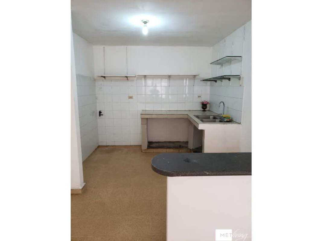 Simple kitchen with white tiles, open shelves, L-shaped counters Villa Lucre Panama City