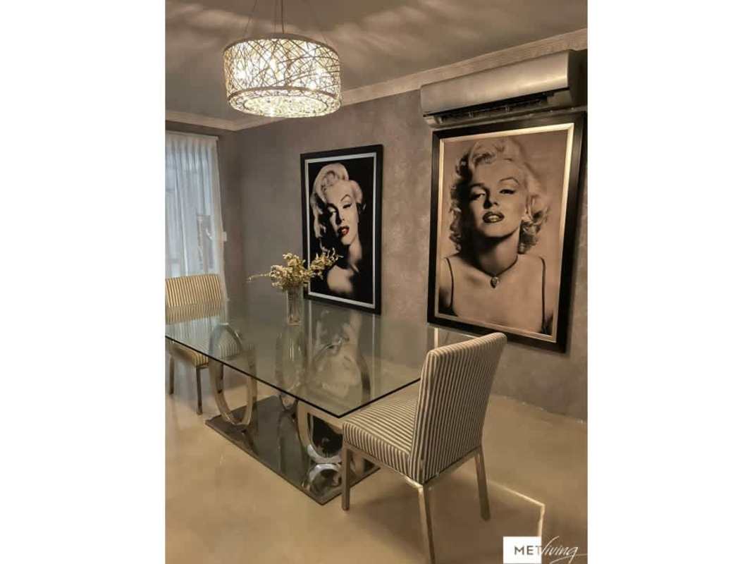 Stylish dining room with glass table, striped chairs, chandelier Crystal Springs Panama