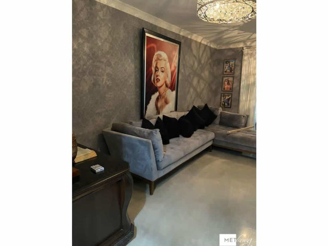 Spacious bedroom with chandelier, upholstered bed, wall-mounted TV in Crystal Springs Pedregal Panama