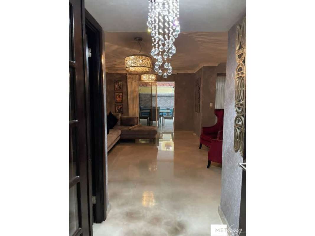 Elegant open-plan living dining area with chandelier in Crystal Springs Residences Pedregal Panama