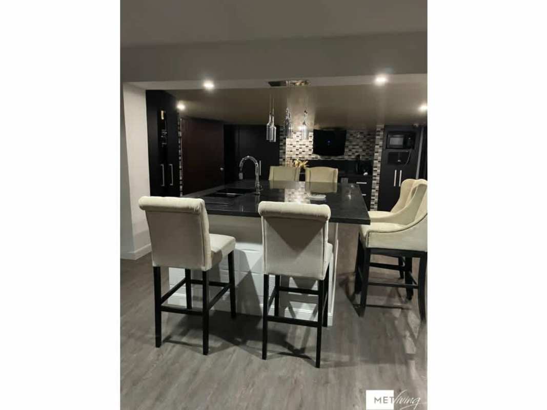 Spacious luxury kitchen with large island modern lighting in Crystal Springs Pedregal Panama City