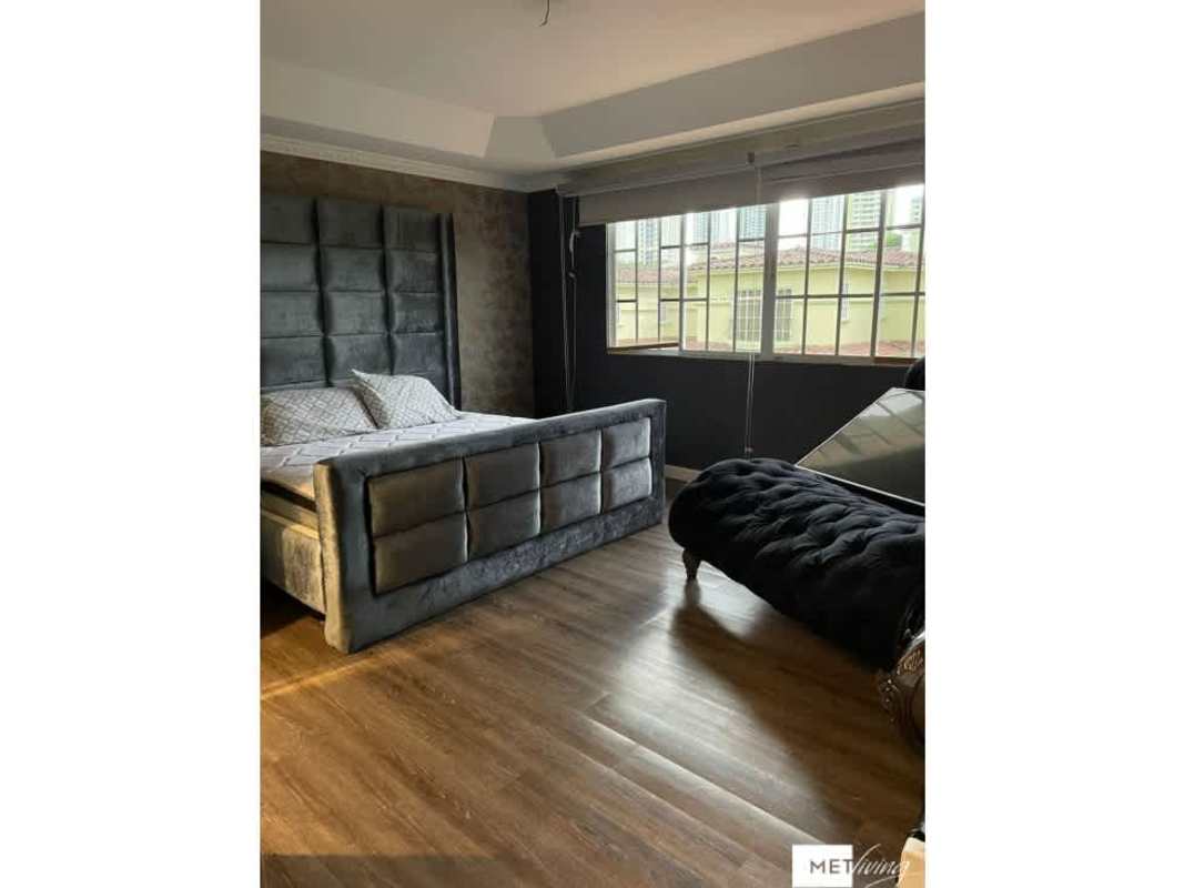 Large modern bedroom with upholstered bed and city view Crystal Springs Pedregal Panama