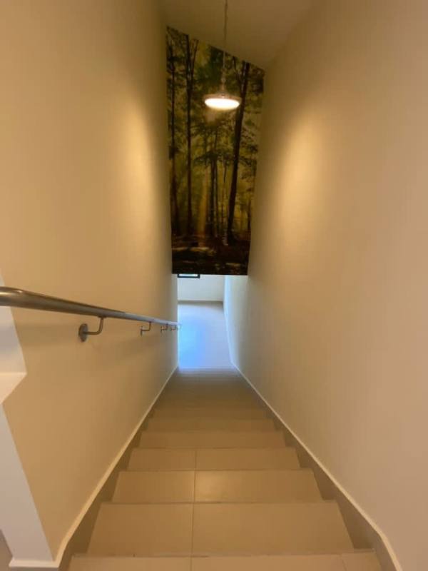 Interior modern staircase with tile steps and decorative canvas in River Valley house Panama