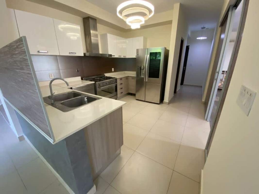 Modern kitchen with granite counters, stainless appliances in River Valley Panama Pacifico home