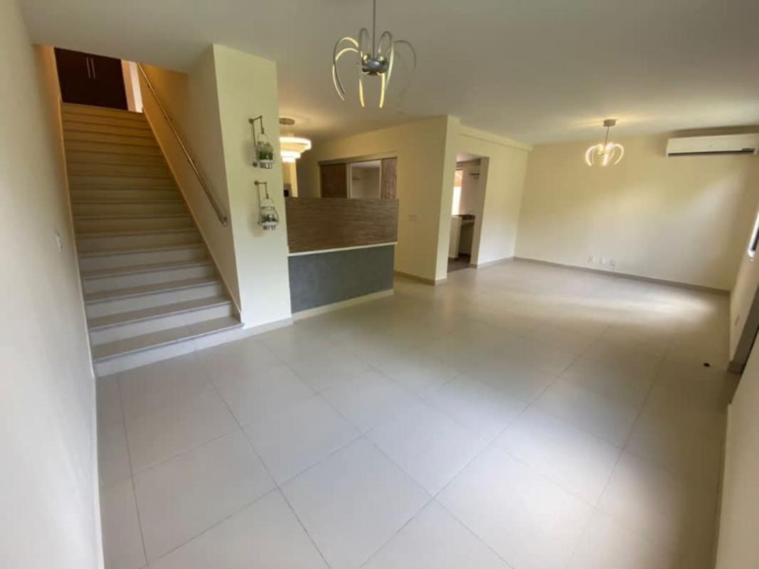 Open living dining space with tile floors and large windows in River Valley Panama